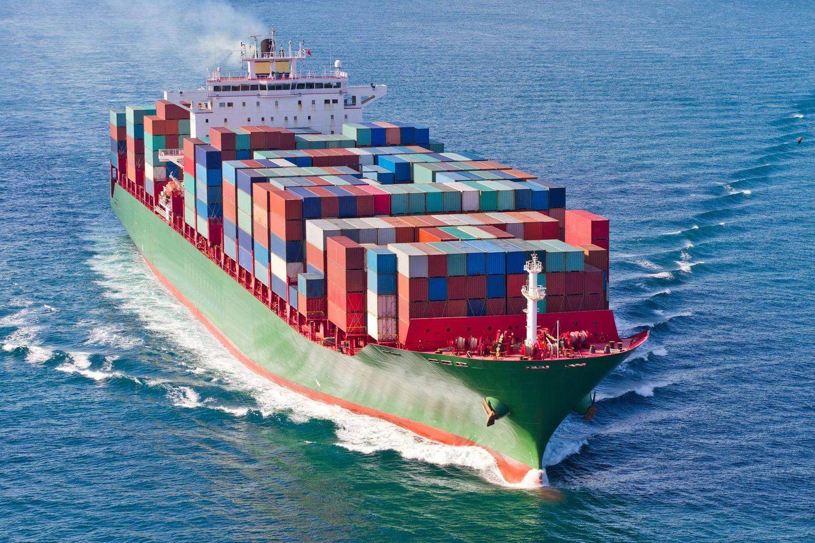 Fully loaded container ship sailing at sea