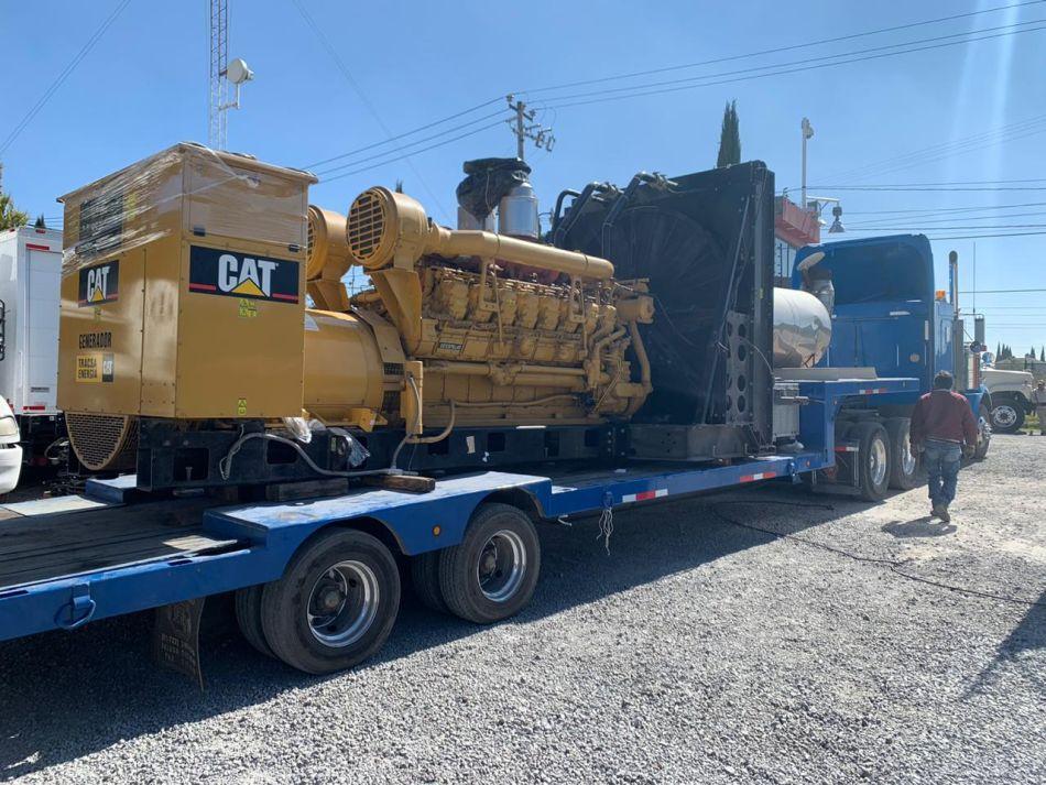 Caterpillar industrial equipment secured on a lowboy trailer